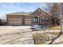 Beautiful two-story brick home with well-manicured lawn and mature trees at 26426 E Peakview Dr, Aurora, CO 80016