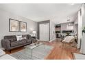 Comfortable living area with hardwood floors, sofa, and an open flow to the dining area at 1745 S Kline Way, Lakewood, CO 80232
