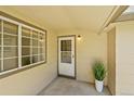 Inviting covered front porch with decorative plant and neutral colors at 10369 E Red Mtn, Littleton, CO 80127