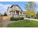 Charming two-story home with stone accents, manicured lawn, and welcoming front porch at 26267 E 3Rd Ave, Aurora, CO 80018