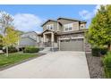 Charming two-story home with stone accents, manicured lawn, and welcoming front porch at 26267 E 3Rd Ave, Aurora, CO 80018