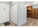 View of the entryway with wood-style flooring, coat closet and access to the kitchen at 615 S Alton Way # 7A, Denver, CO 80247