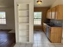 Functional kitchen featuring tile flooring, wood cabinets, and modern sink at 14425 E Albrook Dr, Denver, CO 80239