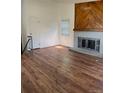 Bright living room with hardwood floors and a brick fireplace at 14425 E Albrook Dr, Denver, CO 80239