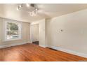 Cozy living room with hardwood floors, bright window, and neutral walls ready for personalization at 723 31St St, Denver, CO 80205