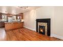 Inviting living room with adjacent kitchen, hardwood floors, and decorative fireplace at 723 31St St, Denver, CO 80205