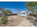 Quaint home with blue trim, gravel yard, and a cozy, inviting exterior perfect for relaxed living at 5424 Saulsbury Ct, Arvada, CO 80002