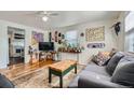 Inviting living room features hardwood floors, a stylish sofa, and eclectic decor for a personalized touch at 5424 Saulsbury Ct, Arvada, CO 80002