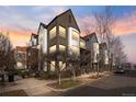 Stunning townhome exterior with brick and modern architectural details at sunset at 425 S Reed St, Lakewood, CO 80226