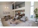 Bright living room with views to the dining room, kitchen and upper level at 7600 S Ulster Ct, Centennial, CO 80112
