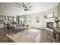Inviting living room with a fireplace, hardwood floors, and natural light, perfect for relaxation and entertainment at 1624 Pinion Wing Cir, Castle Rock, CO 80108