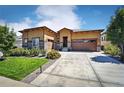 Stunning single-story home with manicured lawn, mature plants, and a large driveway at 26642 E Peakview Pl, Aurora, CO 80016