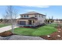 Charming exterior with manicured lawn, three-car garage, and lovely landscaping at 12701 Strawberry Cir, Longmont, CO 80503