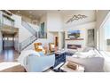 Bright living room with tall ceilings, a fireplace, and modern furnishings at 12701 Strawberry Cir, Longmont, CO 80503