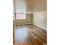 Inviting living room shows bright natural light and neutral colors, with durable wood floors at 1390 Emerson St # 107, Denver, CO 80218