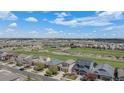 A scenic aerial view of a neighborhood with mature trees, green spaces and a golf course at 11788 Mill Valley St, Parker, CO 80138