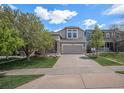 Charming two-story home featuring stone accents, a well-maintained lawn, and an attached two-car garage at 11788 Mill Valley St, Parker, CO 80138