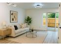 Bright living room features modern lighting, neutral tones, and sliding glass doors to outdoor area at 2218 Coronado N Pkwy # B, Denver, CO 80229