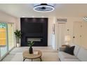 Cozy living room featuring a modern fireplace, shiplap accent wall and lots of natural light at 2218 Coronado N Pkwy # B, Denver, CO 80229