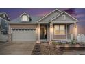 Charming home featuring stone accents, manicured landscaping, and an attached two-car garage at 5521 Ensenada St, Denver, CO 80249