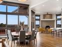 Bright dining area features large windows, a cozy fireplace, and beautiful hardwood floors at 43 Falcon Hills Dr, Highlands Ranch, CO 80126