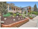 Lovely vintage brick home with a covered porch and professional landscaping, including a terraced brick planter at 3259 Lowell Blvd, Denver, CO 80211