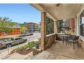 Relaxing front porch with comfortable seating and views of the neighborhood street, featuring vintage brickwork at 3259 Lowell Blvd, Denver, CO 80211