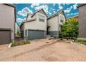 Inviting home exterior with brick driveway and an attached two-car garage at 9723 Bennett Peak St, Littleton, CO 80125