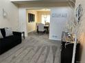 Inviting living room boasts plush carpeting and decor, flowing into the dining area at 19102 E Hampden Dr, Aurora, CO 80013