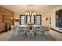 Stately dining room featuring a long table with seating for ten, modern lighting, and hardwood floors at 3309 E 7Th Ave Pkwy, Denver, CO 80206