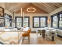 Bright eat-in kitchen featuring custom lighting, brick accent wall, and stylish countertops with seating at 3309 E 7Th Ave Pkwy, Denver, CO 80206