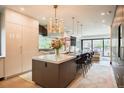Modern kitchen featuring a large island with seating, sleek cabinetry, and stainless steel appliances at 3309 E 7Th Ave Pkwy, Denver, CO 80206