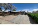 Brick home featuring a long driveway and mature trees at 7620 Hooker St, Westminster, CO 80030