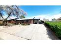 Brick home featuring a spacious driveway, front yard, and inviting curb appeal at 7620 Hooker St, Westminster, CO 80030