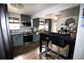 Updated kitchen with gray cabinets, stainless steel appliances, and breakfast bar at 7620 Hooker St, Westminster, CO 80030