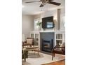 Cozy living room area with a fireplace, built-in shelving, and modern lighting at 3743 N Yates St, Denver, CO 80212