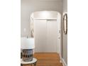 Hallway with hardwood floors and arched entryway, showcasing the home's charm at 3743 N Yates St, Denver, CO 80212