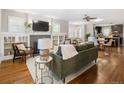 Open-concept living area with hardwood floors, fireplace, and abundant natural light at 3743 N Yates St, Denver, CO 80212