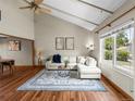 Bright living room features vaulted ceilings, modern decor, and large window views at 10862 Albion Dr, Thornton, CO 80233