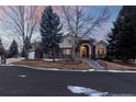 Elegant home exterior with stone accents, manicured landscaping, and a welcoming entrance, perfect for a refined living experience at 4 Arabian Pl, Littleton, CO 80123