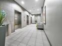 Elegant lobby area with stylish tiled floors, elevator access, and comfortable seating at 891 14Th Street # 1712, Denver, CO 80202