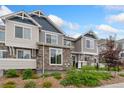 A townhome showing stone and siding accents, updated colors and landscaping including mulch and manicured greenery at 5745 S Buchanan Ct # C, Aurora, CO 80016