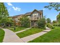 Charming two-story house with a well-maintained lawn and inviting walkway at 8260 E 24Th Dr, Denver, CO 80238