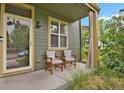 Cozy front porch with seating, perfect for relaxing outdoors at 8260 E 24Th Dr, Denver, CO 80238