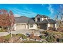 Spacious home with three-car garage and manicured landscaping at 5960 S Watson Ln, Littleton, CO 80123