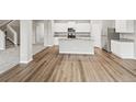 A spacious kitchen with granite countertops, stainless steel appliances, an island, and light-colored wood flooring at 2175 Alyssa St, Fort Lupton, CO 80621