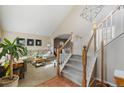 Bright entryway with hardwood floors, a staircase, and an open view to the living room at 1033 Quarterhorse Trl, Castle Rock, CO 80104