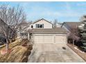 Attractive home featuring a three-car garage and a spacious driveway for easy parking at 1033 Quarterhorse Trl, Castle Rock, CO 80104