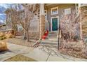Inviting front entrance with colorful flower pots enhancing the home's curb appeal at 1552 Venice Ln, Longmont, CO 80503