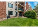 Condo backyard with lawn, patios and balconies at 401 S Kalispell Way # 104, Aurora, CO 80017